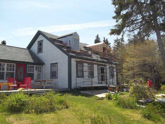 Exterior view of two dormers windows being added to attic space