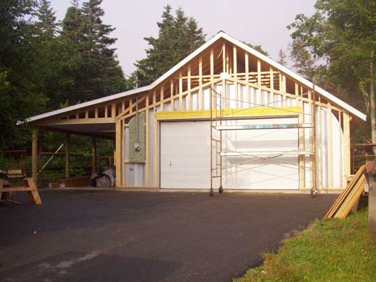 Gable end walls framed up, and roof installed over Quonset hut