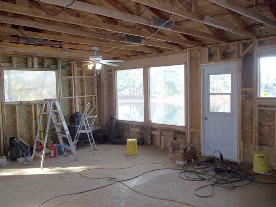 New wiring, plumbing, and new windows being installed in cottage