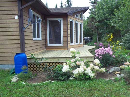 Another view of new wraparound deck added to existing home.
