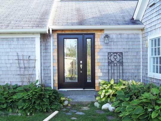 Elegant new entrance door with side light installed in existing home