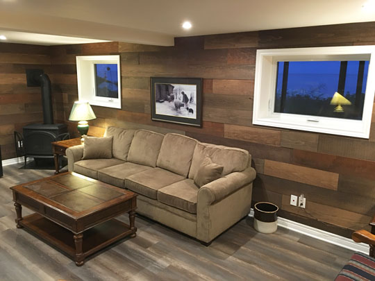Renovated basement room becomes inviting home entertainment centre. Renovation by Mark Oickle.