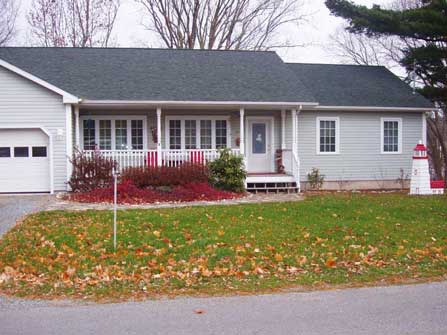 Large single storey new home with attached garage, and front covered porch.