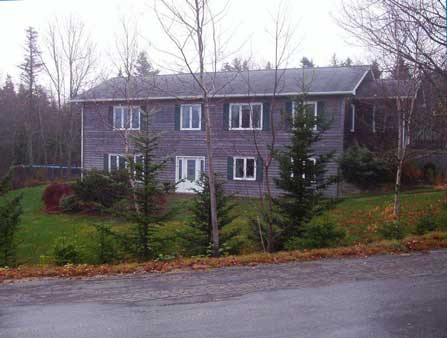 New two-storey home with wood siding, and plenty of windows